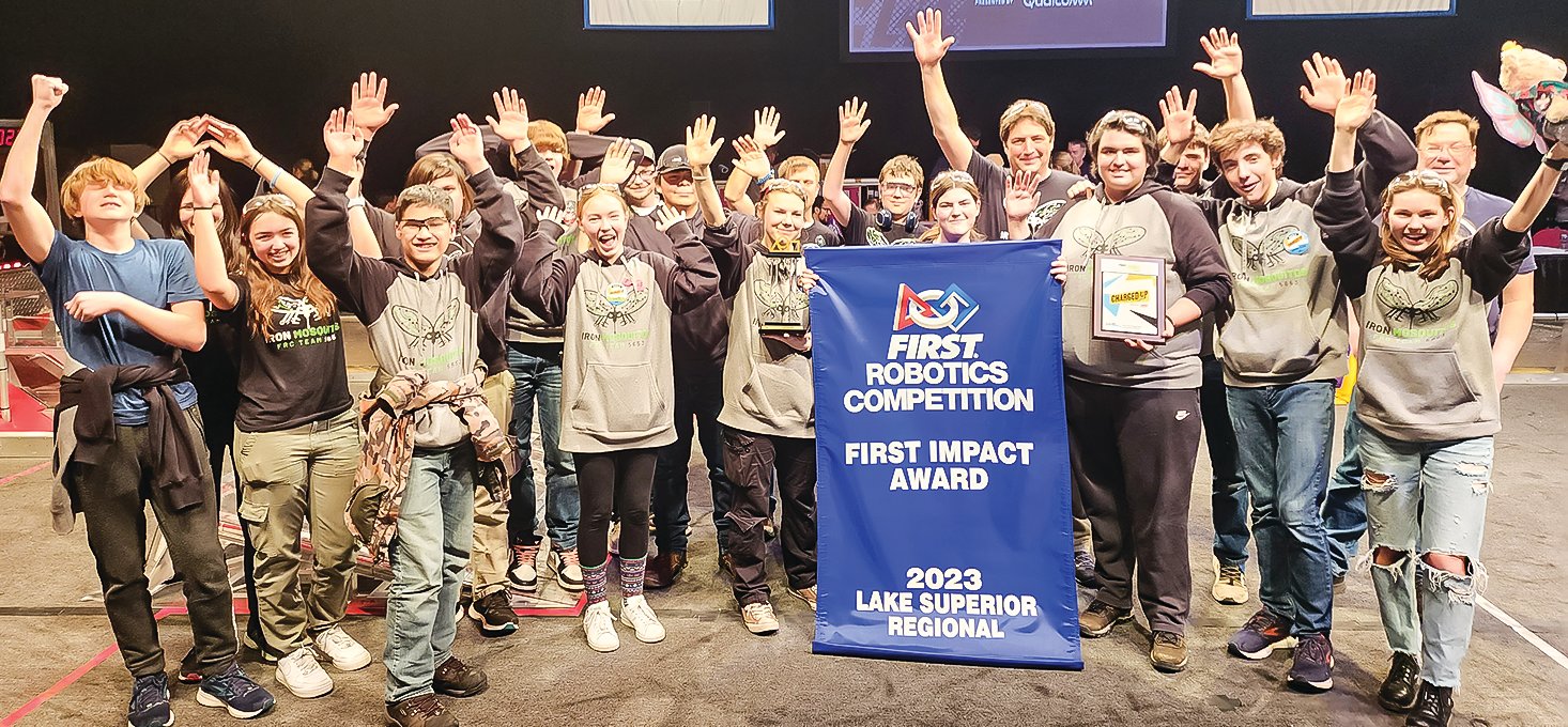 The Iron Mosquitos celebrate after winning the First Impact Award at the Lake Superior regional competition.