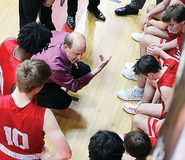 Ely Head Coach Tom McDonald gestures as he talks endgame strategy with his team during the final minutes of the Bigfork game.