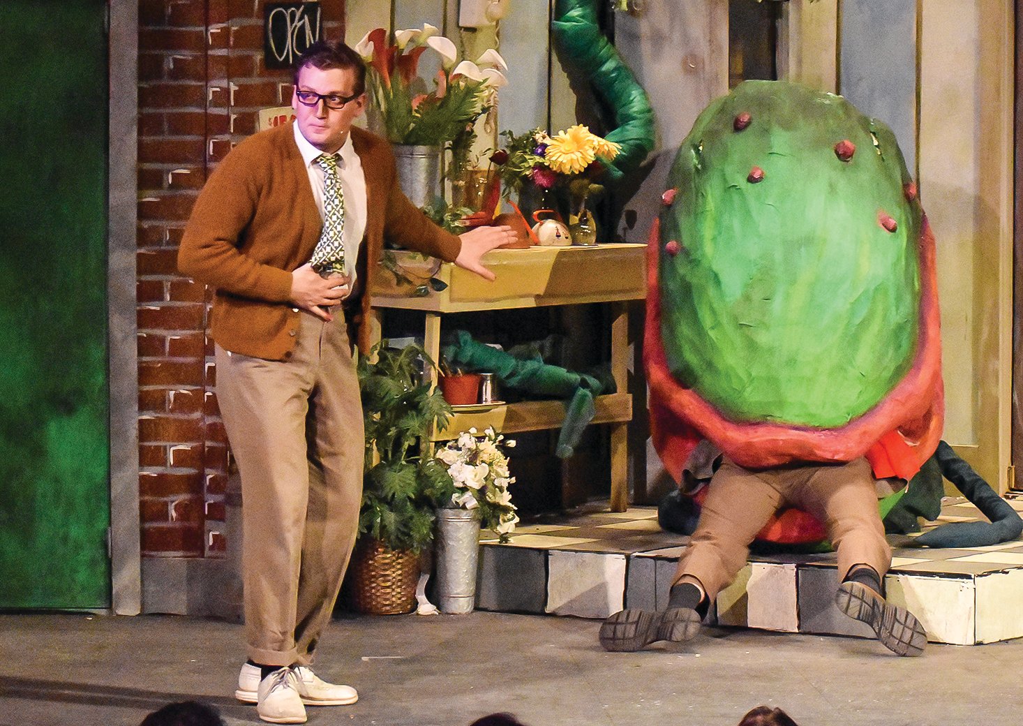 Ian Lah, in his portrayal of Seymour Krelborn, reacts as he discovers that the carnivorous plant, Audrey II, is 
devouring a human victim.