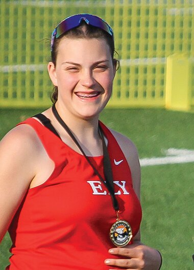 Eighth-grader Kaylin Visser is all smiles at the medals table after securing a first place finish in discus at the Iron Range Conference varsity championship on Tuesday.
