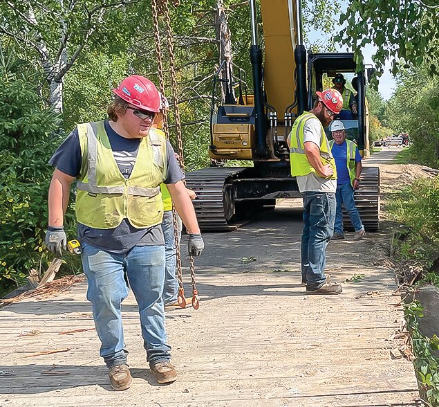 Workers were busy dismantling the dilapitated Mesabi Trail bridge over the East Two River on Tuesday. Work on the bridge should be completed by the end of the month.