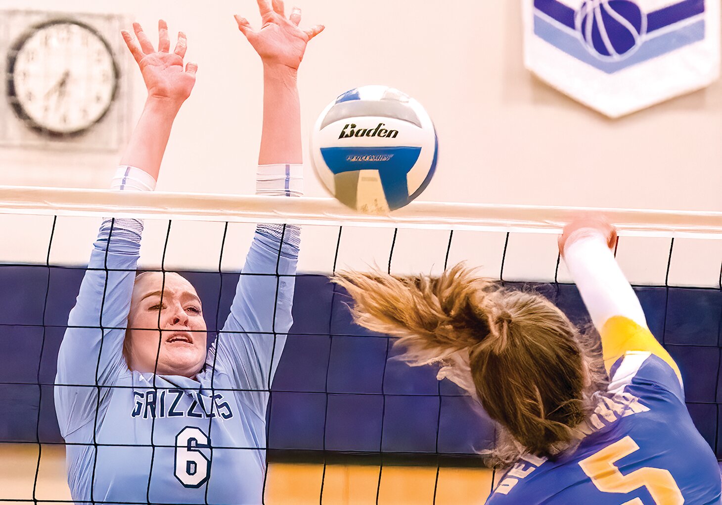 North Woods’ Addy Hartway goes up high for a block during their clash with Deer River on Monday.
