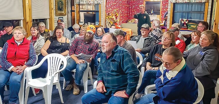 The meeting room on Owens Town Clerk Shirley Woods’ property was packed for Tuesday’s annual town meeting, with many attendees interested in the controversy over Derusha Rd.