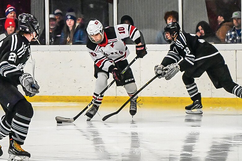 Ely junior forward Brady Eaton maneuvers the puck through heavy traffic during Monday’s home contest with North Shore.