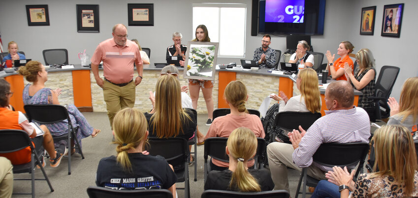 Owensville High School student River Dahms receives applause Monday at the R-2 School District&rsquo;s Board of Education meeting for earning 10th place in the Color Photography competition during the National Beta Conference in Texas earlier this summer.