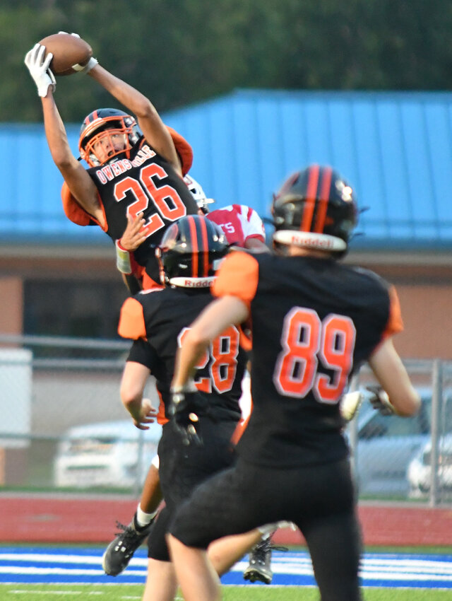 Chase Crosby (far left) jumps up fully extended to intercept a pass for Owensville&rsquo;s Dutchmen against Linn&rsquo;s Wildcats during Friday football jamboree action last week at Hermann High School&rsquo;s Bearcat Memorial Stadium. OHS hosts Central (Park Hills) this Friday night at Dutchmen Field in their season opener.