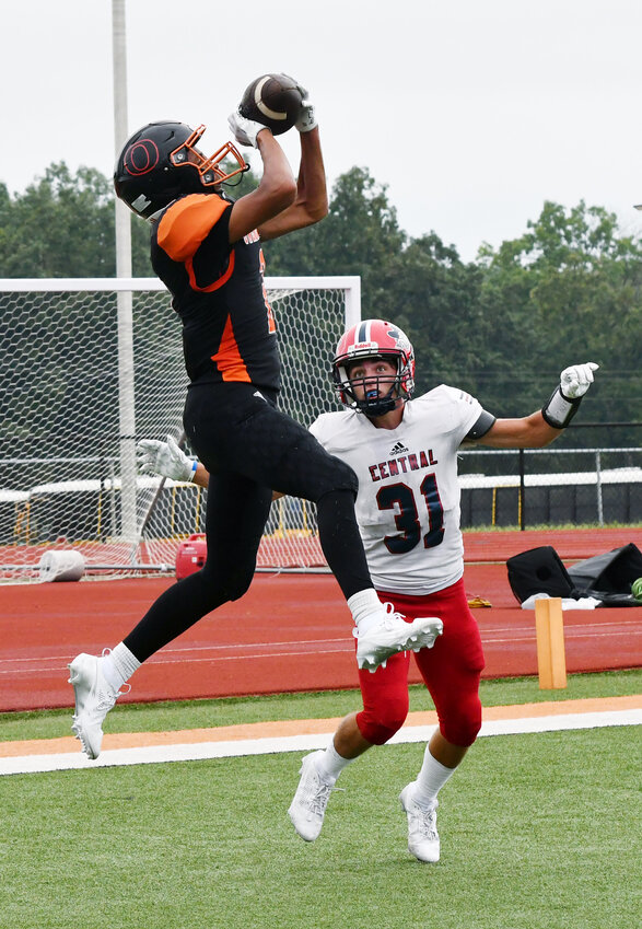 Zaiden Gates (left) leaps in the air to catch a touchdown pass from Adam Wilson during Owensville&rsquo;s 22-13 season-opening loss Saturday afternoon at Dutchmen Field against Central&rsquo;s (Park Hills) Rebels.