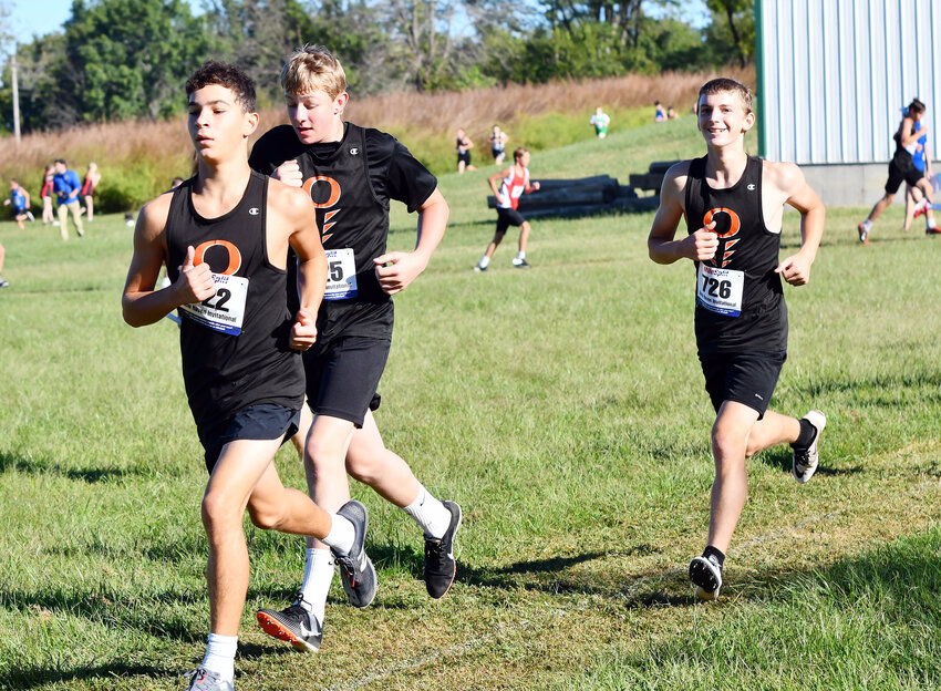 OMS cross country runners (above, from left) Grayson Lairmore, Ricky Ringeisen and Robbie Rodriguez compete during the middle school boys division race at Saturday’s New Haven Invitational.