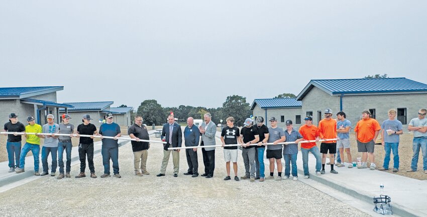 Lt. Gov. Mike Kehoe cuts a ceremonial ribbon on Thursday during the opening of the new Safety Village at State Tech. He was joined by Regents President John A. Klebba, VP Steve Sellenriek, State Tech President Dr. Shawn Strong, and students.