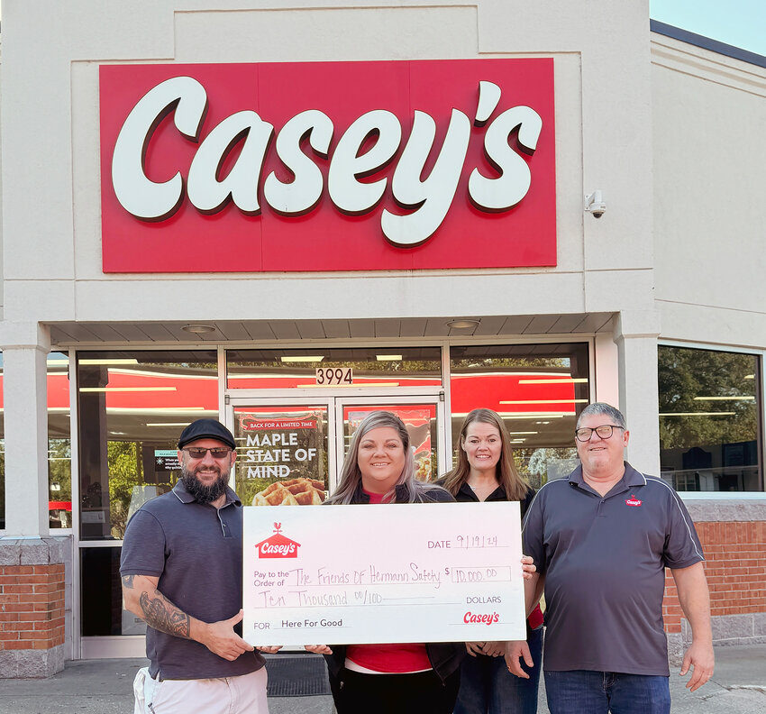 Josh Dodorico accepts a $10,000 check from Casey’s Region Director Jamie Norton, store manager Emily Kemp, and district manager Gary Anthony.