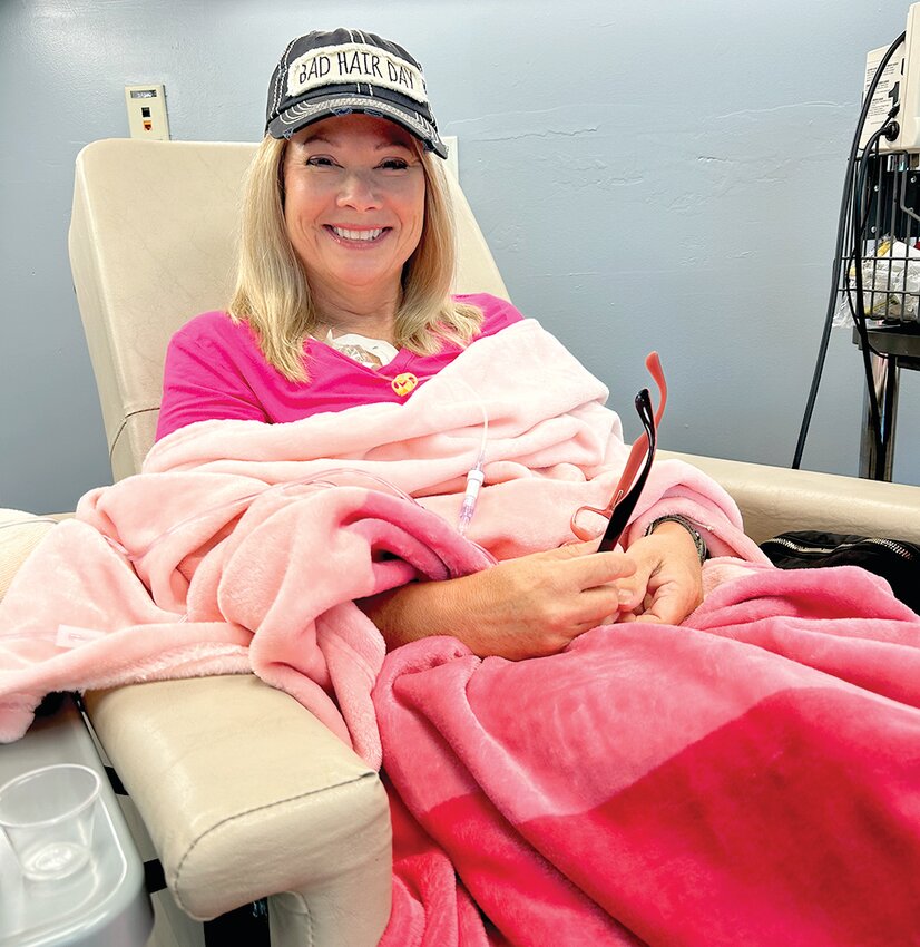 Kim crede of Loose Creek is smiling in this photo of a treatment in Jefferson City. She praises integrative treatments and a positive attitude for her recovery from breast cancer.