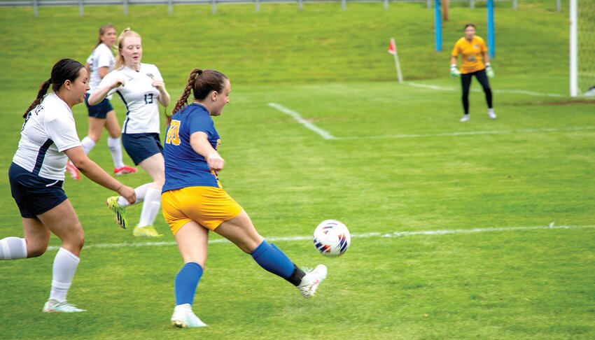 Carmen Falter, above left, kicks the ball toward Battle&rsquo;s net in last week&rsquo;s game. Above, Haley Titus pushes the ball up the field at Stover. Below, Lexi York looks to clear the ball from the backfield, also in the Stover game.