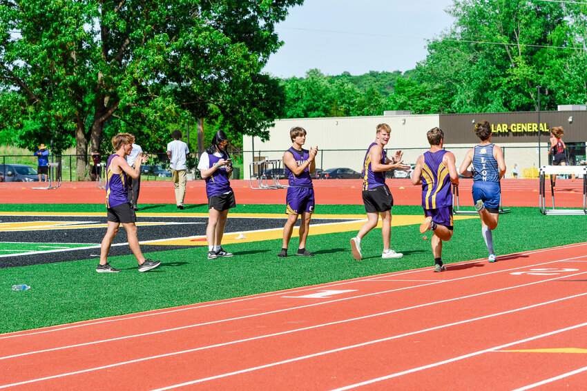 CHAMOIS TRACK athletes cheer on teammate Caleb Keilholz as he runs the 3200m event at last weekend's sectional meet. He qualified for state.