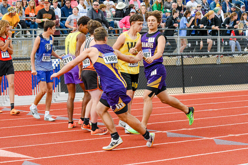 Caleb Keilholz takes the baton from Bill Kirsch in the 4x800 at last weekend&rsquo;s Class 1 state track meet in Jefferson City. Below, Brayden Cotton fires the shot put.