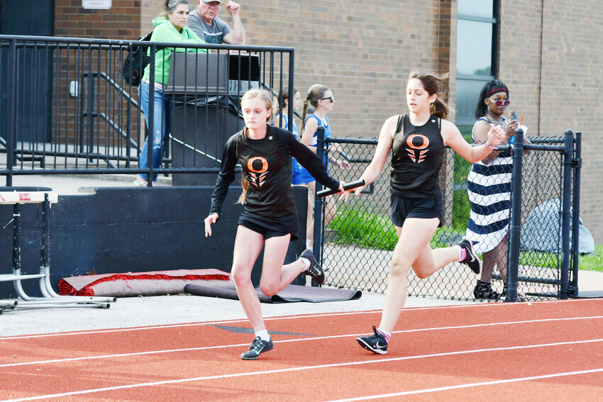 Leah Hays (above, left) grabs the baton from Novalie Schatzler for Owensville Middle School (OMS) track and field during the Union Middle School (UMS) Relays held in early May at Union High School&rsquo;s E.A. Stierberger Stadium closing out their season.