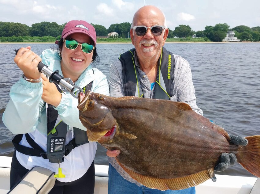 OUT OF WARWICK: Shaina Boyle and Gary Vandemoortele, of Smithfield, with a 27” summer flounder caught fishing with Capt. Dave Monti of Warwick, on a slope in the Newport Bridge area last year.