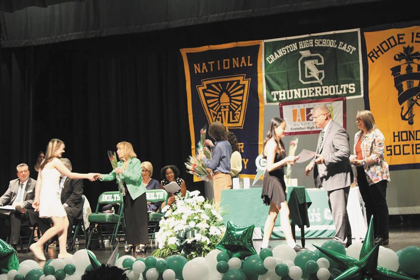 Students shake Cranston East Principal Thomas Barbieri’s hand as they receive the awards for the night.