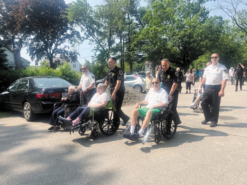 Members of the Johnston Police Department gave some wheelchair users a hand – and made sure they stayed under the speed limit.