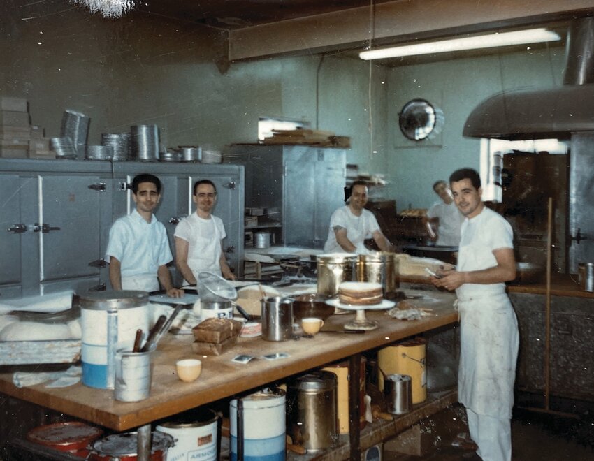 In this undated photo from the Solitro family, the four sons of founder Michael Solitro – from left, Larry, Michael II, Armando and George – work
hard in the bakery. Together, they carried on the business. (Photo courtesy of the Solitro family)