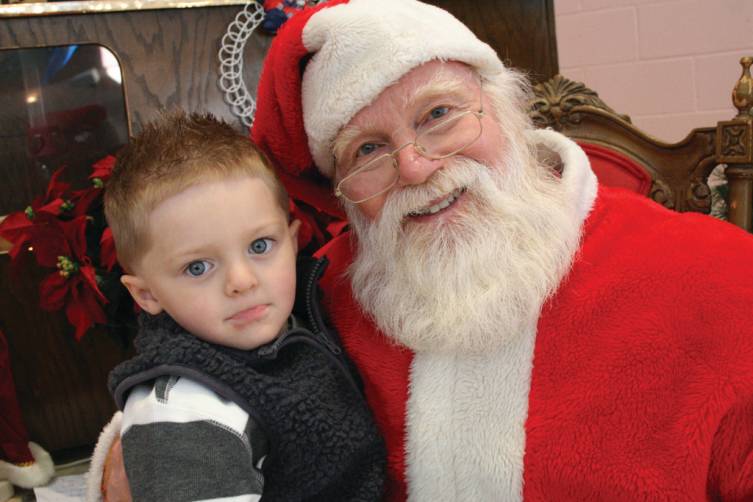 Braiden sits on Santa's lap.