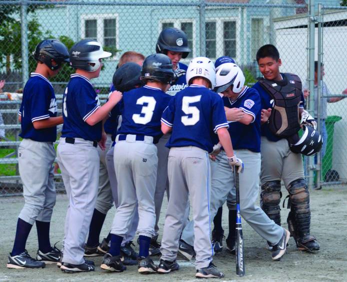 GREETINGS: Teammates mob Matt Martinez after his home run gave Continental a lead in the eight inning of Friday's City Series third-place game.