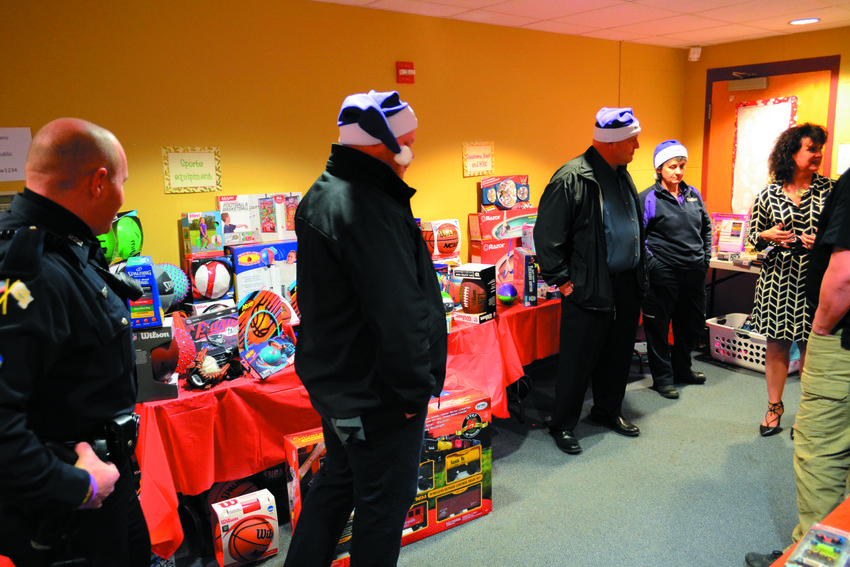 THE NORWOOD POLE: Lara D&rsquo;Antuono shows members from local FedEx operations facilities and Warwick community police officer Geoff Waldman around the Norwood branch, which was decked wall-to-wall with toys, games, clothing and presents of all kinds.