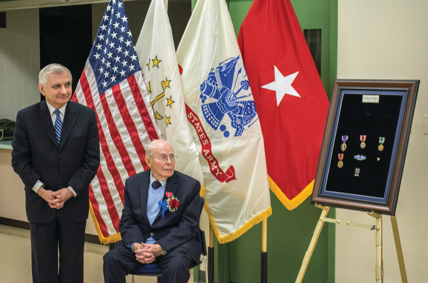 WWII MEDALS: Senator Reed presents Willard Voigt with Bronze Star, Purple Heart, and other medals.