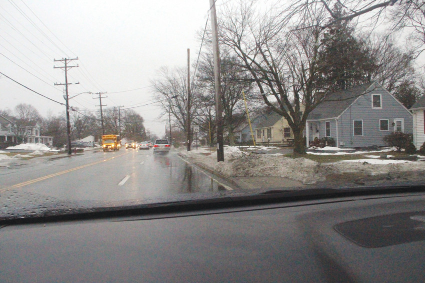 WHAT SIDEWALK? Even though snow melted with last Friday&rsquo;s downpour, traffic was constricted on Main Avenue and sidewalks mail carriers might have used to make their deliveries were impassable.