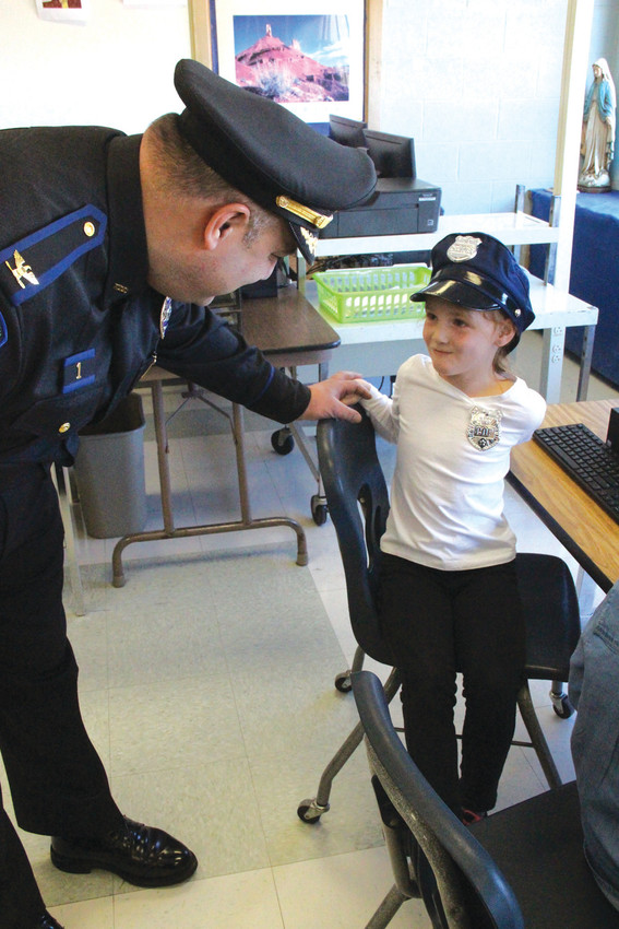 ROLE MODEL: Eliza Abedon, a kindergarten student at St. Kevin School, came dressed as a police officer for &lsquo;career day&rsquo; during Catholic Schools Week. She got a chance to talk to North Providence Police Chief David Tikoian Wednesday morning.