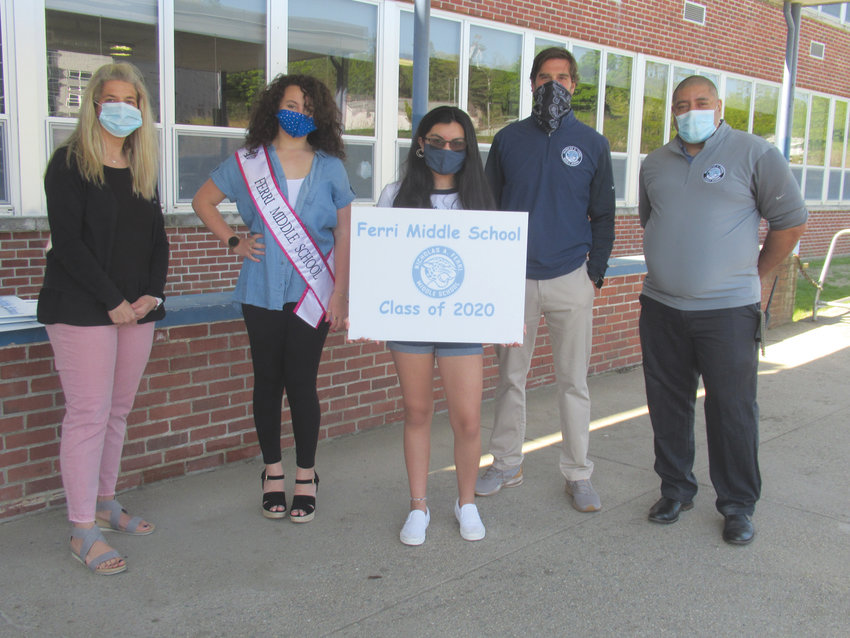 In 2020, Diana Rosales, an outgoing eighth-grader at Nicholas A. Ferri Middle School, proudly displayed the specially made lawn signs that Principal Matthew Tsonos presented to members of the graduating class. They&rsquo;re joined by Lisa Hunt, Nicki Aucone and Assistant Principal Freddie Skipworth.
