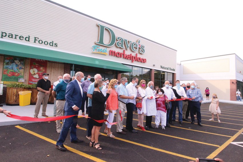 MAKING IT OFFICIAL: Ribbons fly moments before 9 a.m. Friday, when doors to the new store opened