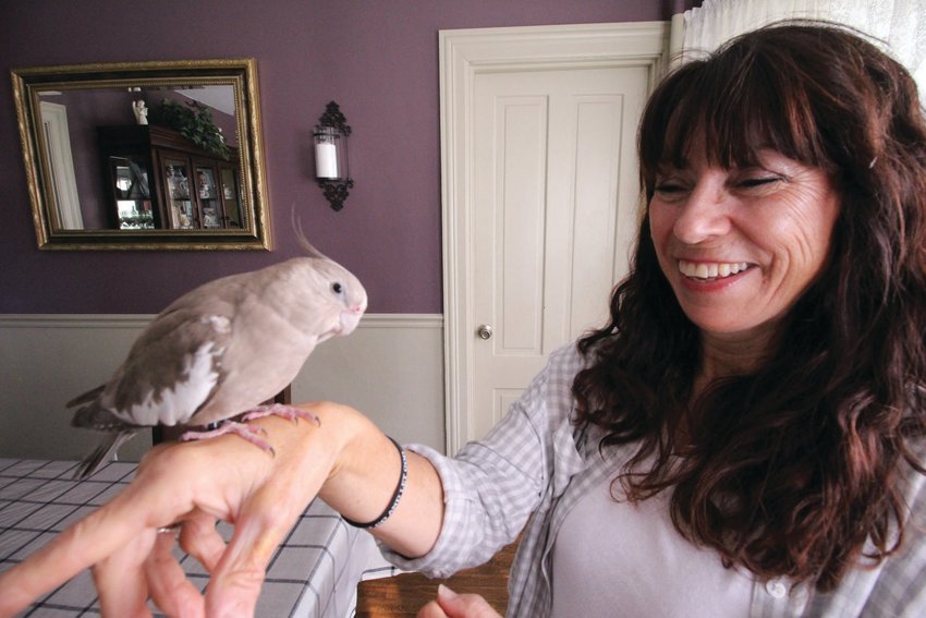 HOME AGAIN: Lidia Goodinson with her pet cockatiel, Joy.