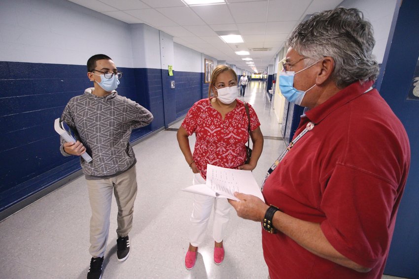 PREPARED TO COME BACK: Roy Costa, who is overseeing the soon-to-be kindergarten wing of Vets, talks with Arelis Diaz and her son Galileo Gonzalez yesterday at the school. The west wing of the school will house special education students. The east wing is strictly for kindergarten under the plan approved Tuesday by the School Committee.