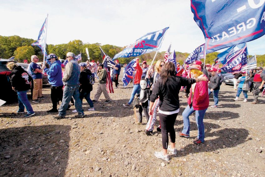 ON THE MARCH: Flag-waving Trump supporters paraded from the Rocky Point parking lot to a meeting area in from of the fishing pier.