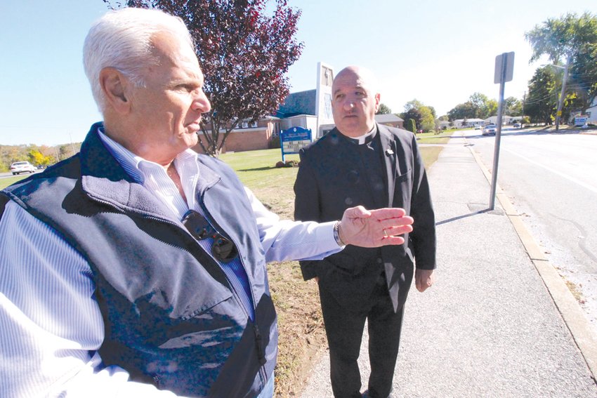 WHERE IT WOULD GO: Ward 5 Councilman Ed Ladouceur and Fr. Robert Marciano at the site of a proposed Sandy Lane crosswalk.