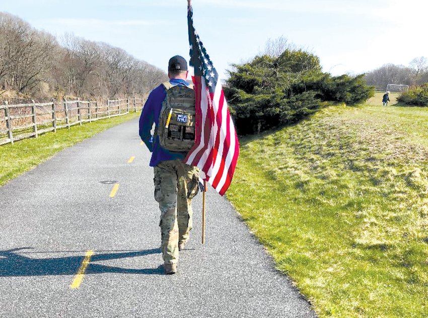 &lsquo;CARRYING THE WEIGHT&rsquo;: Jeff Crowley demonstrates &ldquo;rucking,&rdquo; or walking with a weighted pack. He will participate, along with Brooke van Eeghen, in the &ldquo;Carry The Fallen&rdquo; event on Dec. 12.