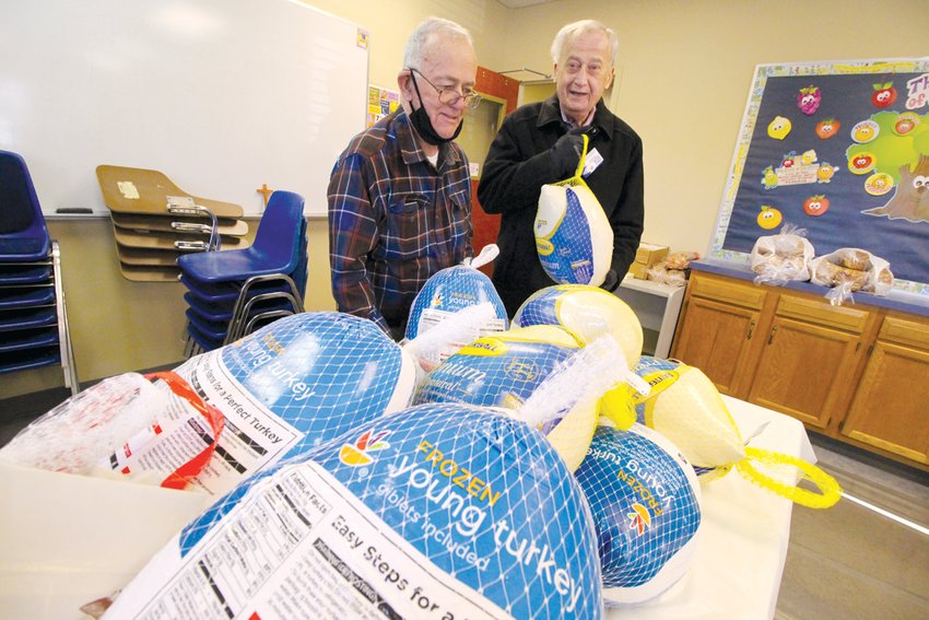 VETERAN VOLUNTEERS:&nbsp;Tom McGovern, 86 and Bob Benz, 78, figure they have worked the church holiday food drive for at least the past 35 years. And for most of that time they&rsquo;ve managed the turkey detail.