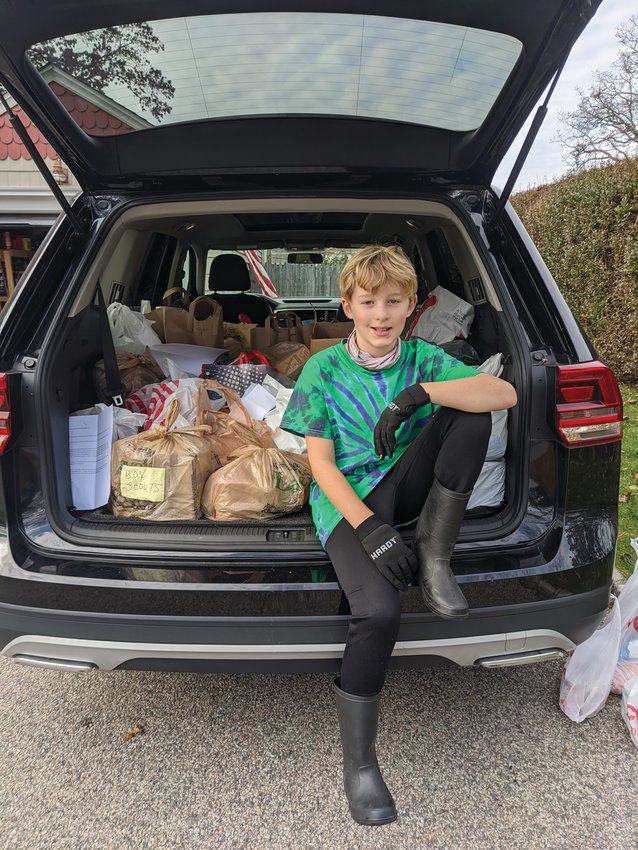 AMAZING RESULTS: Jack proudly shows off all the donations he was able to provide to the Rhode Island Community Food Bank through his one-man food drive.