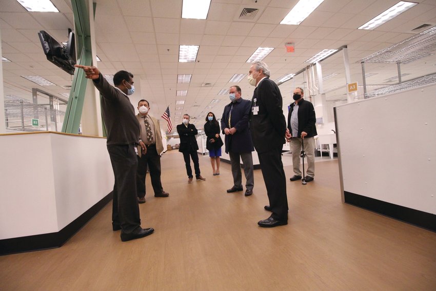 MONDAY TOUR: Dr. Paari Gopalakrishnan, Kent Hospital&rsquo;s chief medical officer, left, and hospital president Robert Haffey, right, gave legislative leaders a tour of the Cranston field hospital before it admitted its first patient later in the day. The hospital is expected to have 10 to 20 patients by the end of this week.