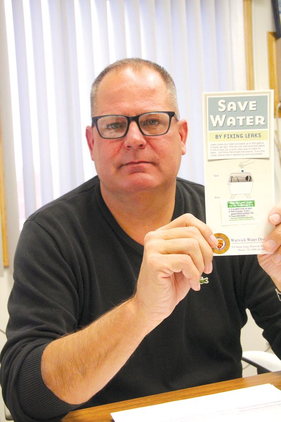 CHECK FOR LEAKS: Terry DiPetrillo, chief of the Warwick Water Division, holds one of the cards the city distributes enabling customers to check for a toilet leak.