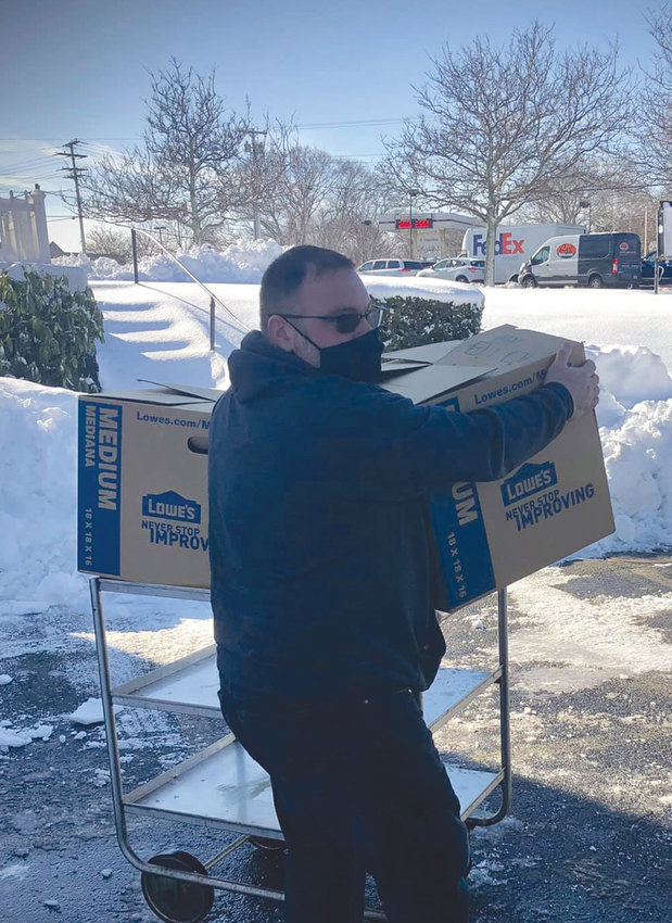 HELP THY NEIGHBOR:&nbsp; Joe Burns, Grand Knight, is pictured here loading boxes into waiting cars at the Knights of Columbus Hall on Sandy Lane. Members from the Warwick council provided 25 Christmas meal baskets to Westbay Community Action in the &ldquo;No Neighbor Left Behind&rdquo; charity campaign.