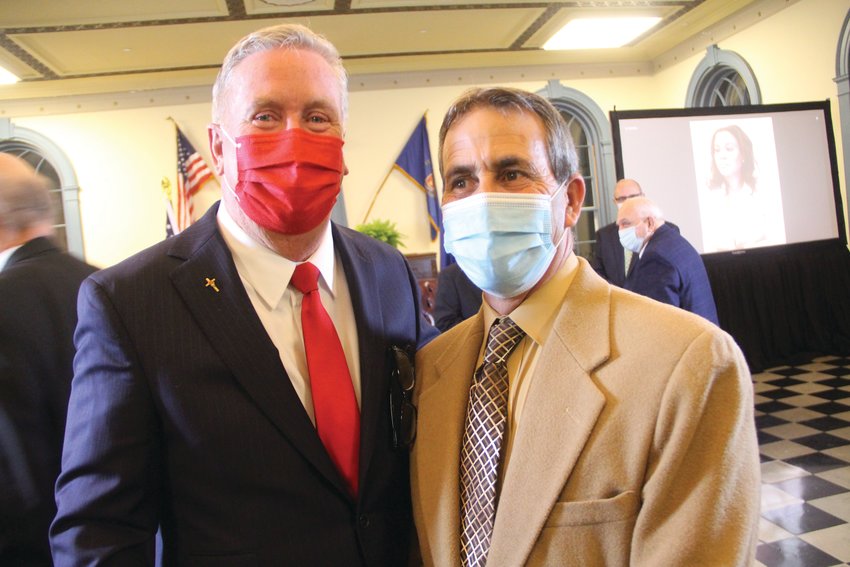 NEXTDOORMAYORS: Cranston Mayor Ken Hopkins, left, and Warwick Mayor Frank Picozzi  share a moment during Hopkins&rsquo;s inauguration ceremony in January.