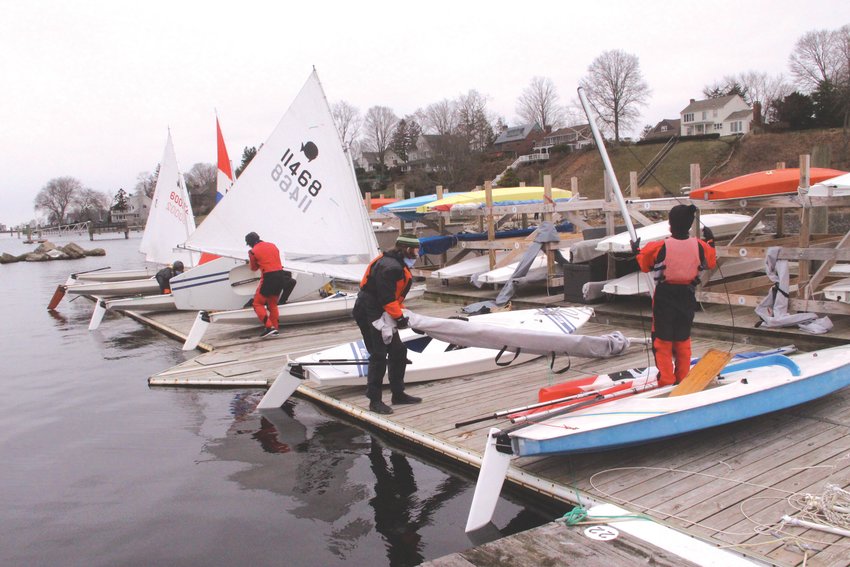 PREPARATIONS: Members of the Frozen Few ready their Sunfish for a Sunday morning of races from the Edgewood Yacht Club docks.