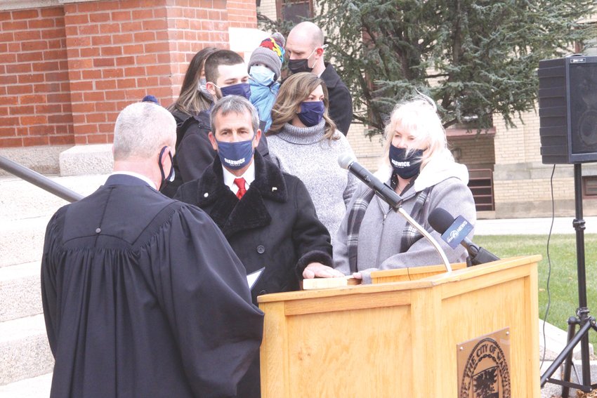 UNDER OATH: With his wife, Kim, holding a Bible and his right hand raised, Mayor Frank Picozzi takes the oath of office as administered by District Court Justice Stephen Isherwood.