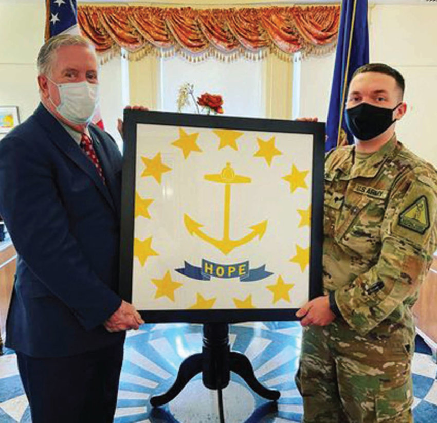 FOREVER MAY IT WAVE: SPC William Naylor presents former teacher and Cranston Mayor Ken Hopkins with a special Rhode Island flag that he traveled with for 10 months throughout the Middle East during his deployment.