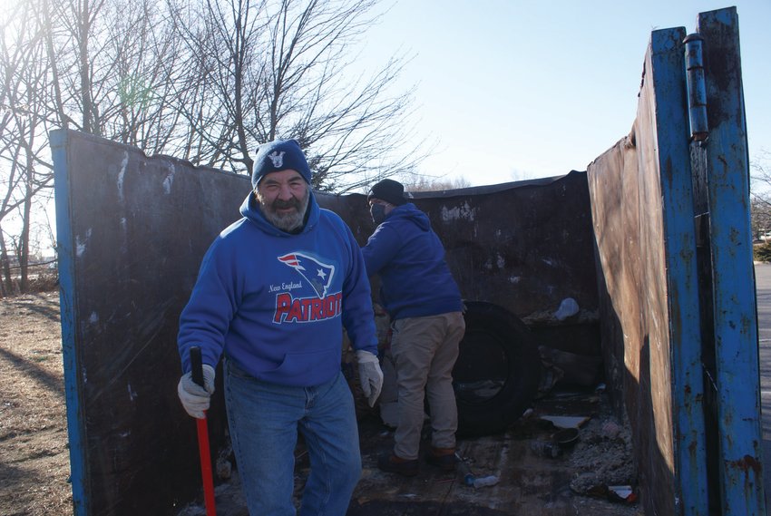 PACKING TRASH: Pictured is Robert Nero, chairman of the Pawtuxet River Authority &amp; Watershed Council, as volunteers began loading the dumpster with trash found around Tongue Pond.