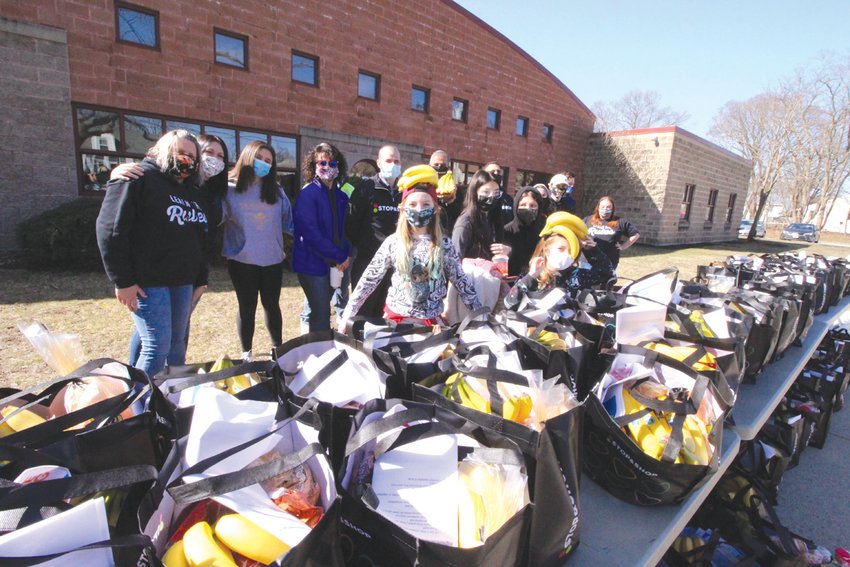 READY FOR THE TAKING: Warwick Boys and Girls Club staff and members are joined by Stop &amp; Shop managers and its district director after the bags were lined up for distribution outside the Norwood Club. As the turnout was not as strong as forecast, bags not handed out went to the Westbay Marketplace that will be handing out food this weekend.