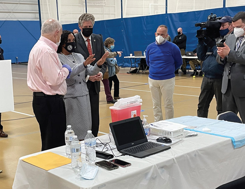 STEPPING UP: Providence City Council President Sabina Matos, center, visits the COVID-19 vaccination clinic at the Johnston Recreation Center on Wednesday. Looking on are Johnston Mayor Joseph Polisena, left, and Gov. Dan McKee.