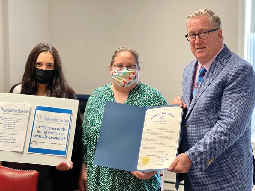 RAISING AWARENESS: Stephanie Joyal and Rachel Caliri from the Elizabeth Buffum Chace Center meet with Cranston Mayor Ken Hopkins for the signing of a proclamation in recognition of Sexual Assault Awareness Month.