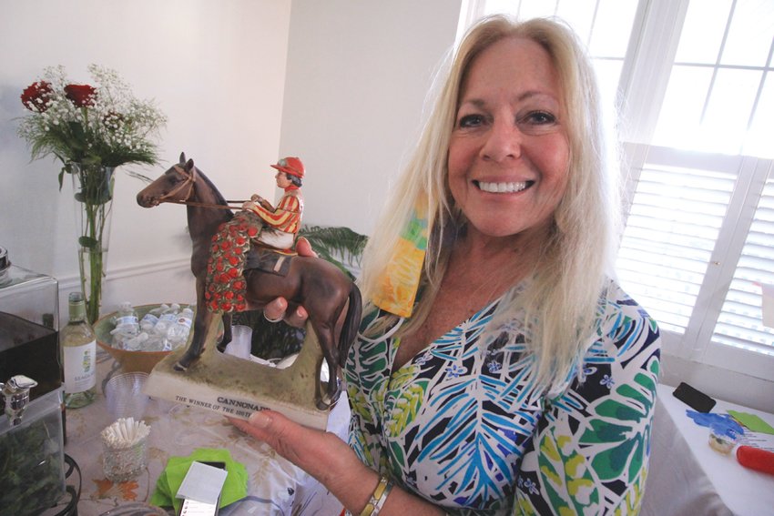 SHE HAS A HORSE IN THIS RACE: EBCC executive director Judith Earle displays the bourbon decanter in the likes of Cannoade, the winner of 100th Kentucky Derby held 49 years ago. Judith&rsquo;s late husband, John, gave it to her. The bourbon has long since gone.